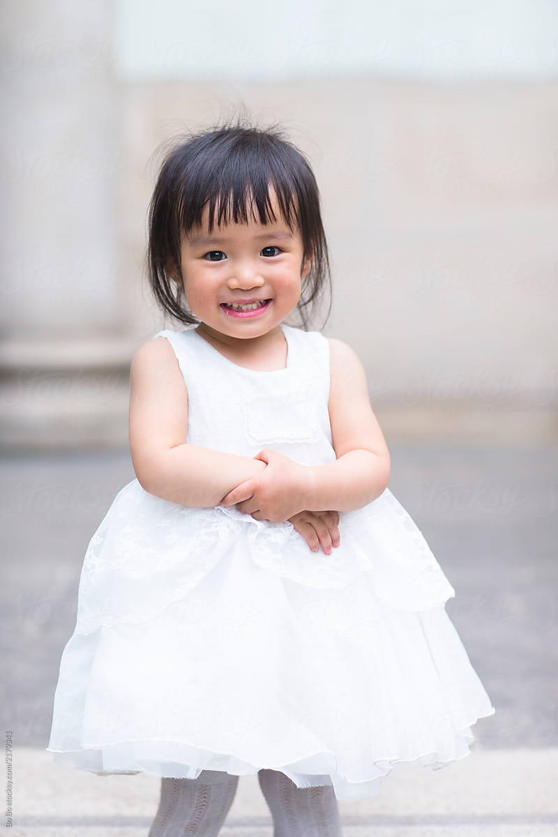 Lovely Chinese Toddler Girl In White Skirt by Stocksy Contributor Bo Bo  - Stocksy
