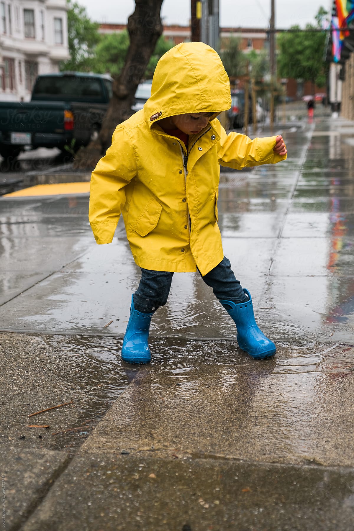 Small boy playing in puddle