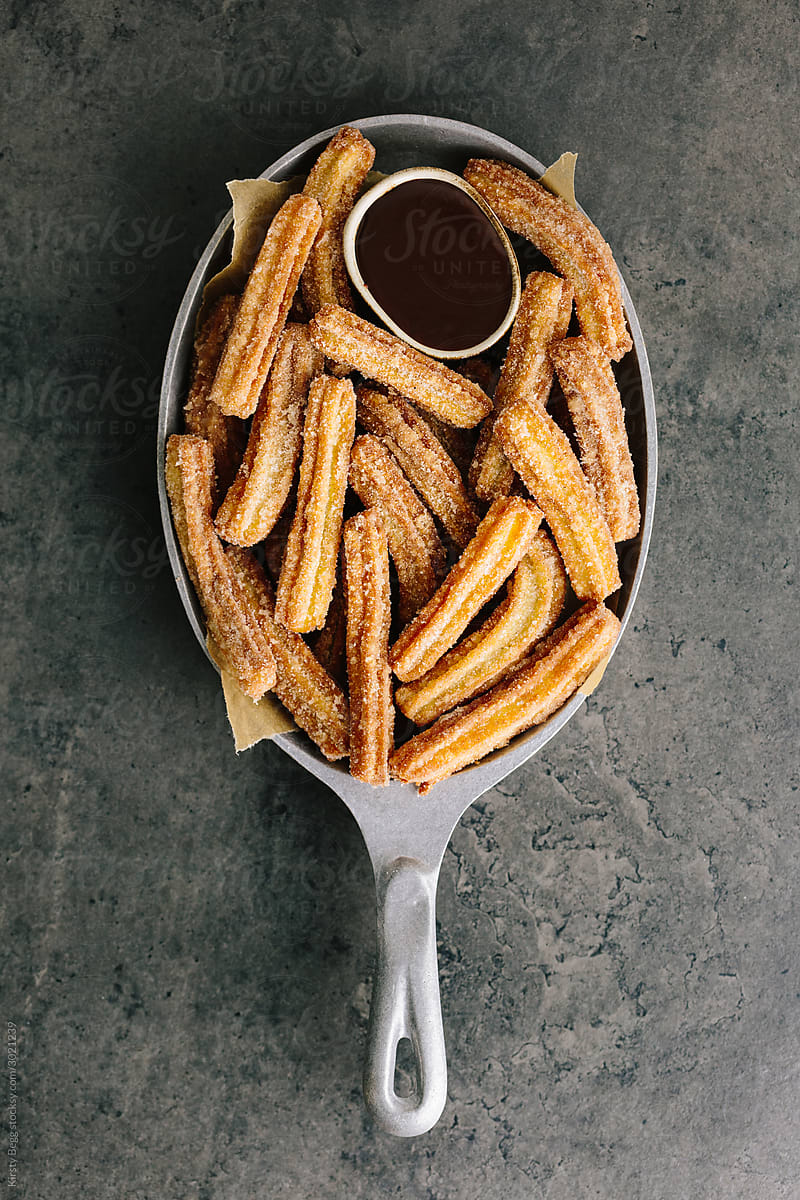 Pan of churros with chocolate dipping sauce