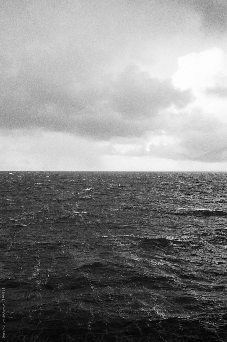 Minimal black and white 35mm film landscape of irish sea during storm