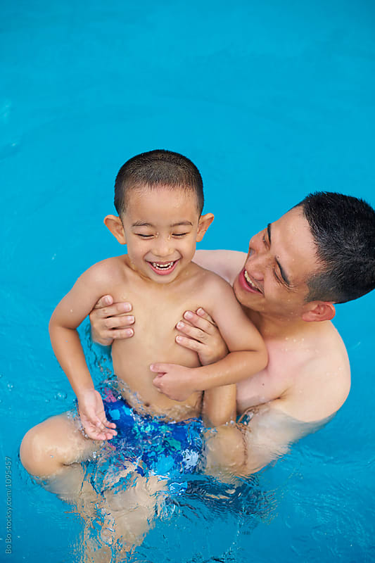 happy father with his son in the swimming pool