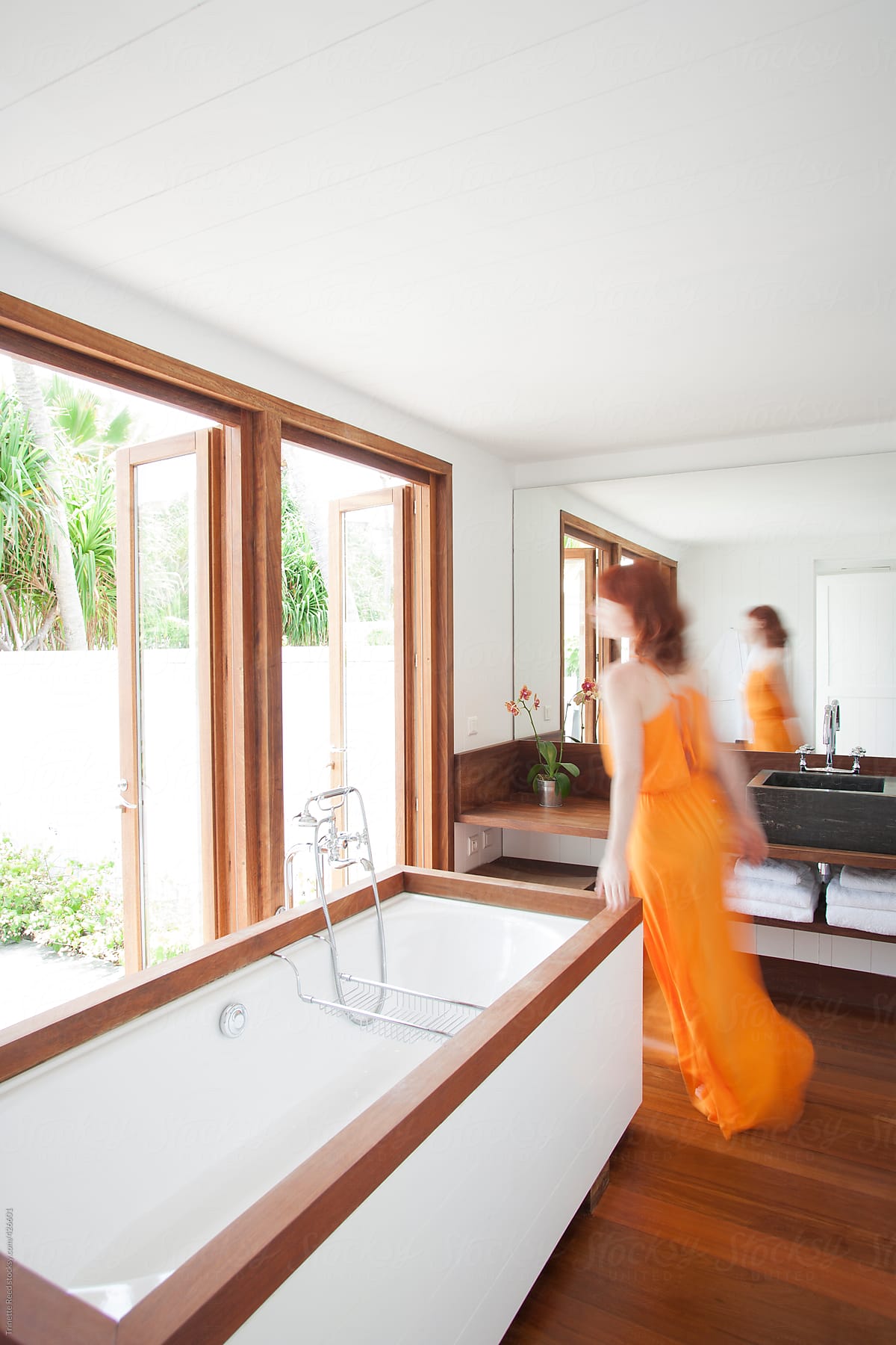 "Woman Walking Through Modern Design Bathroom Of Hotel" by Stocksy ...