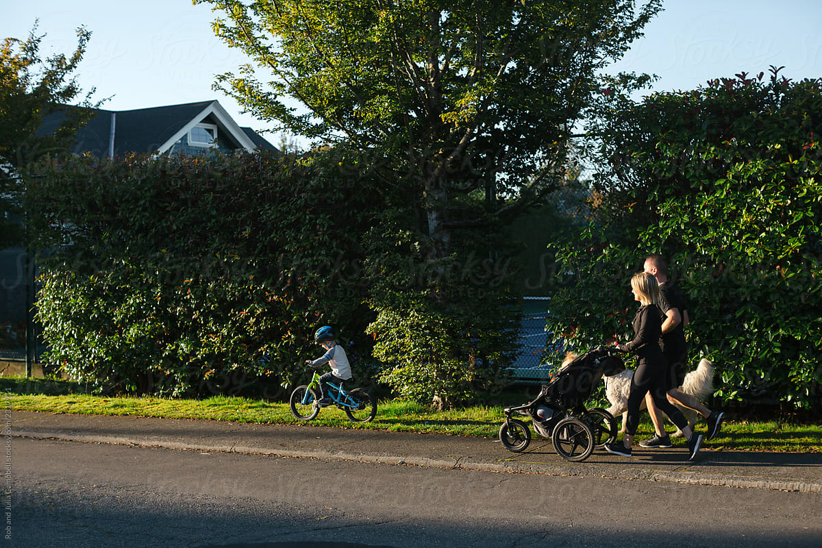 Family of four jogging together