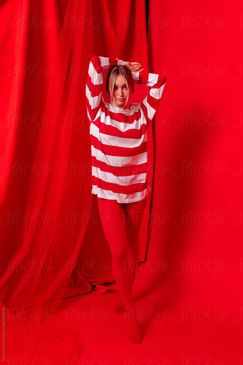 Stylish young female model in striped sweatshirt