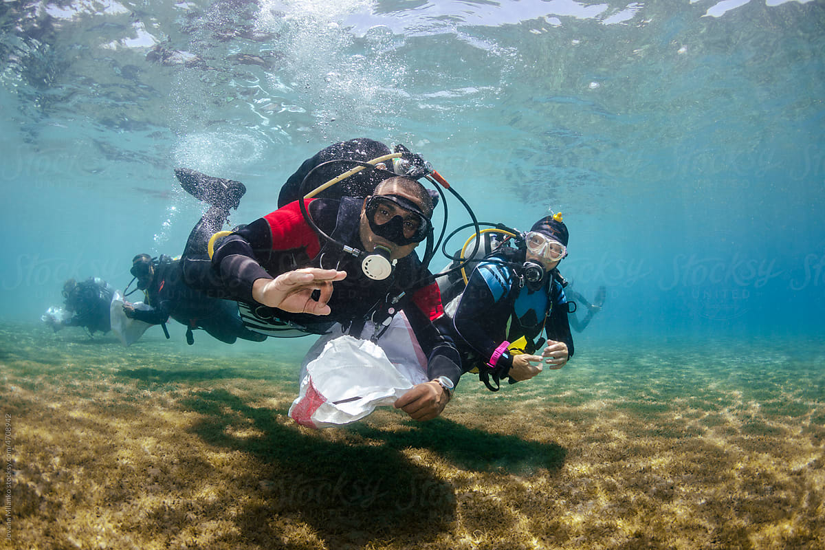 Group of Scuba Diver Activists Cleaning up the Ocean