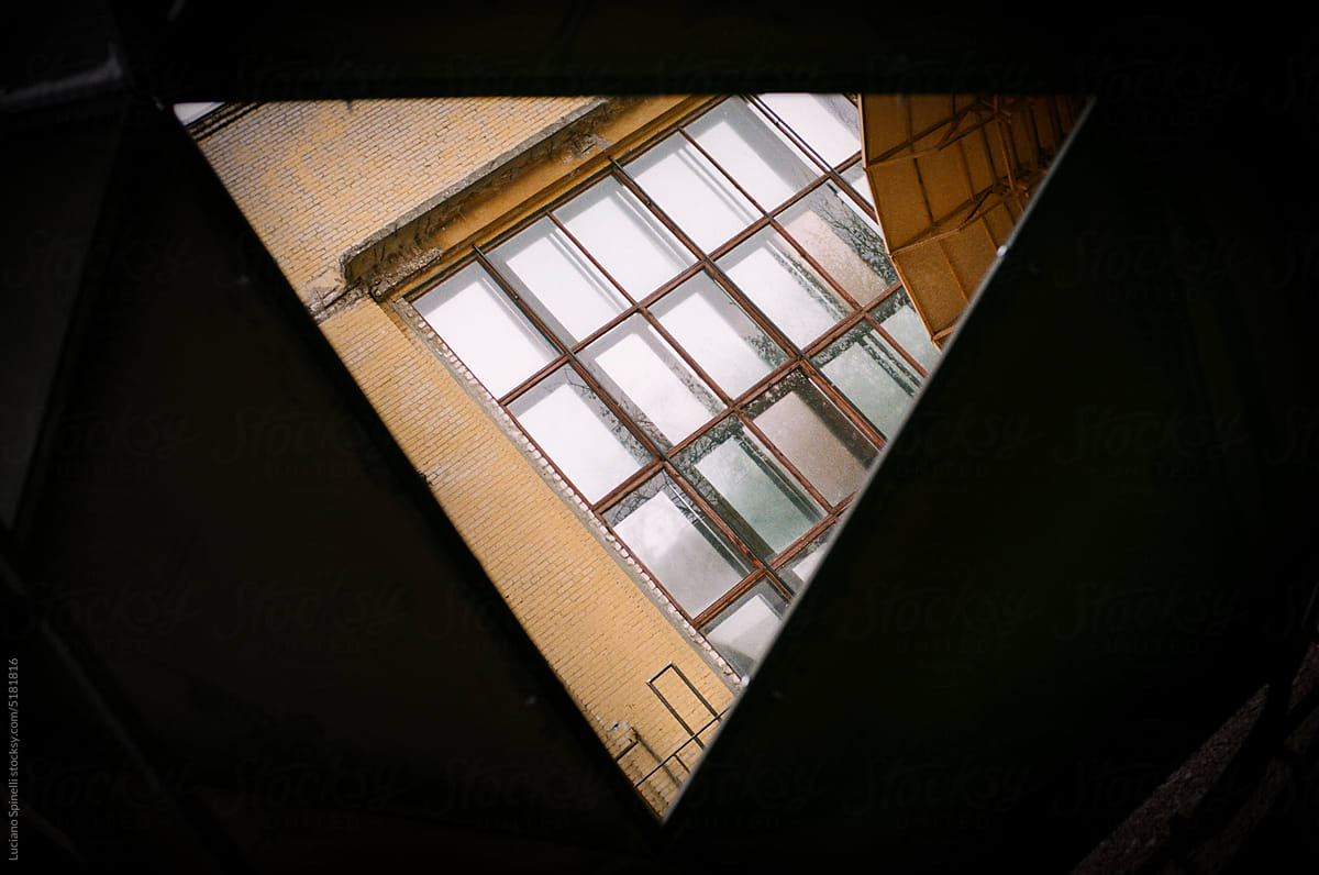 View through the inverted triangle of a building with windows