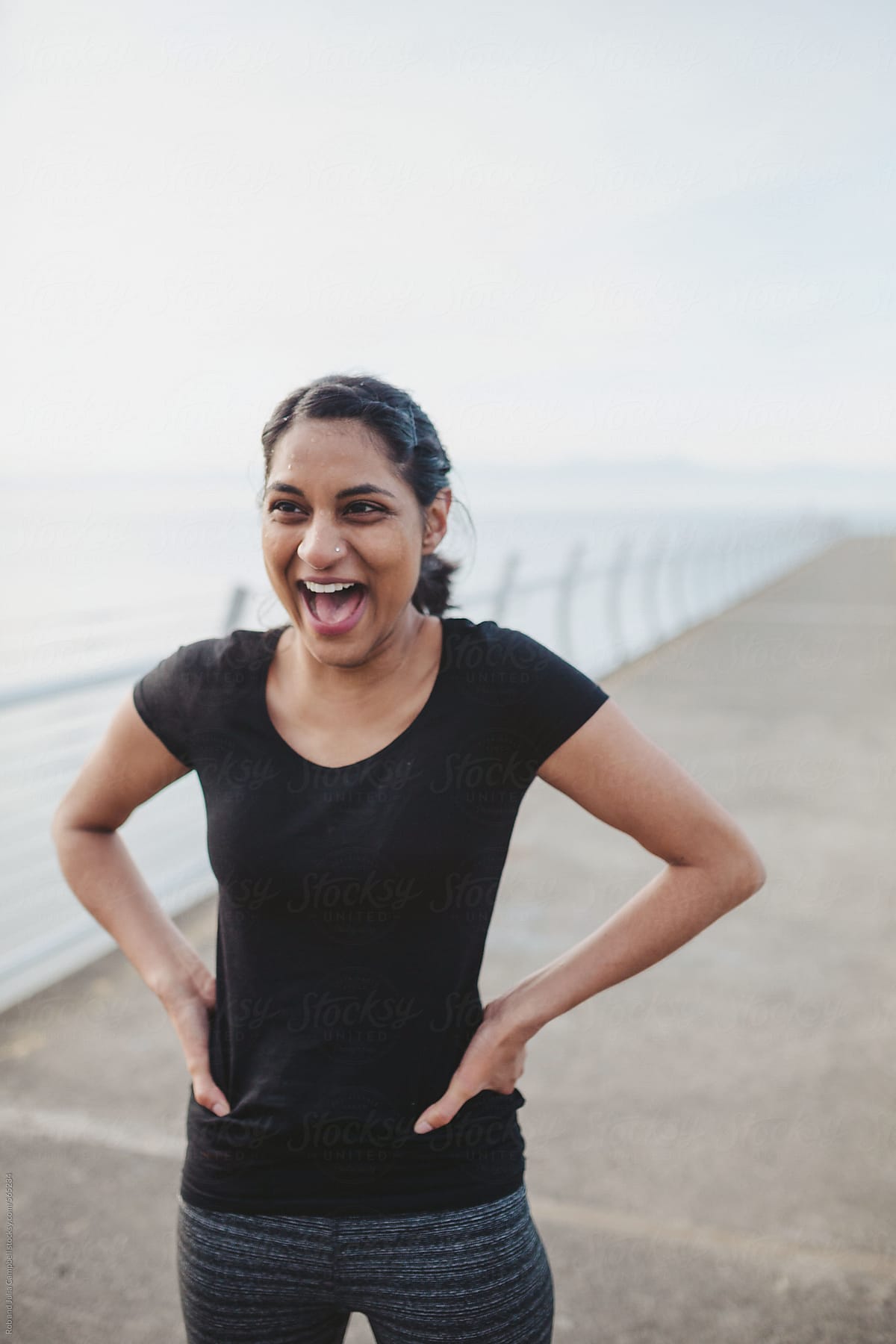 Young East Indian Woman Tired And Happy After Hard Run Workout Sweaty