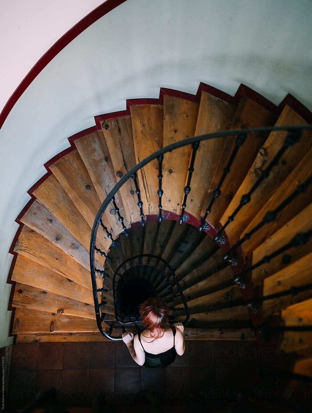 woman lookind down spiral stairs