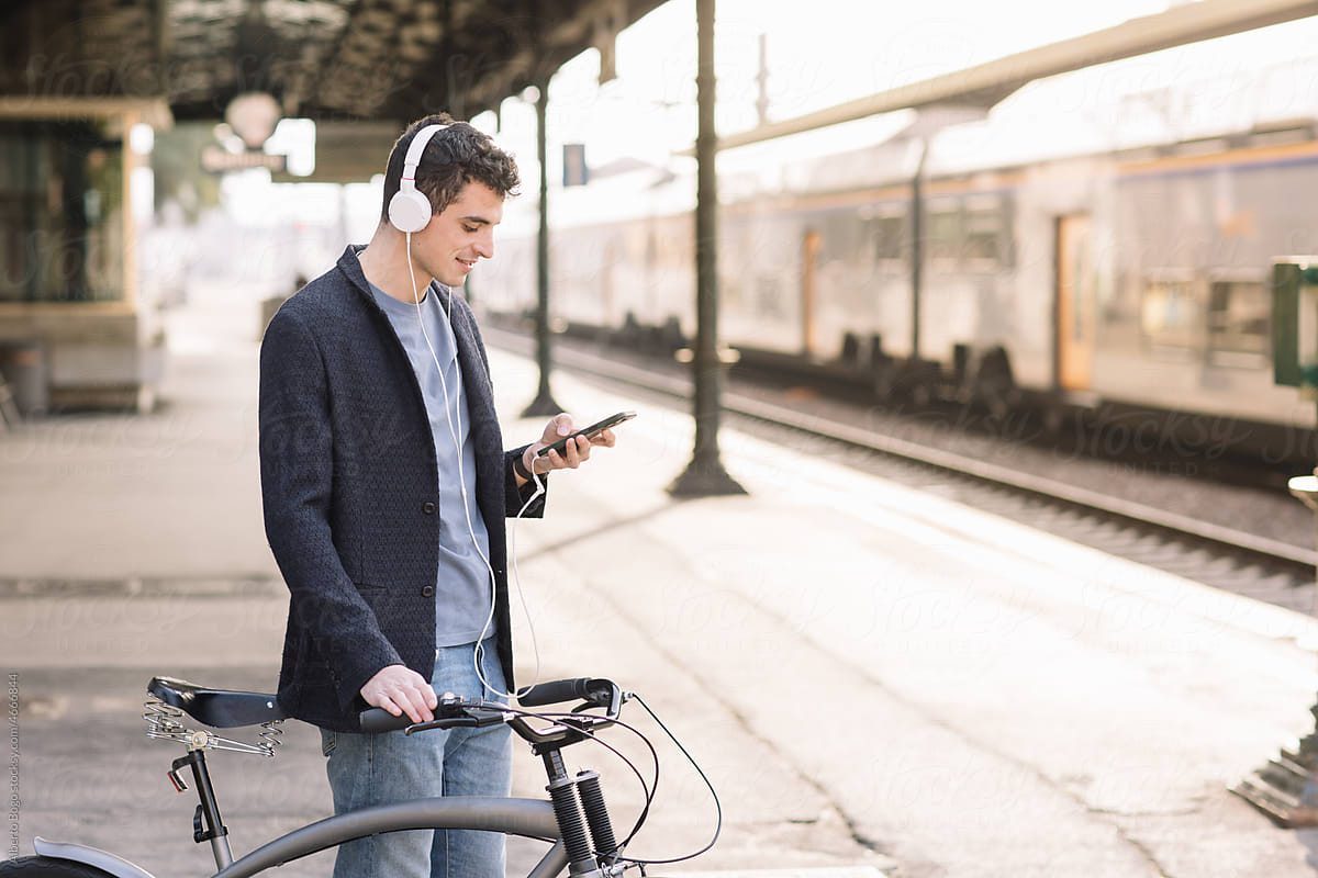 Boy Listening To Music At Train Station