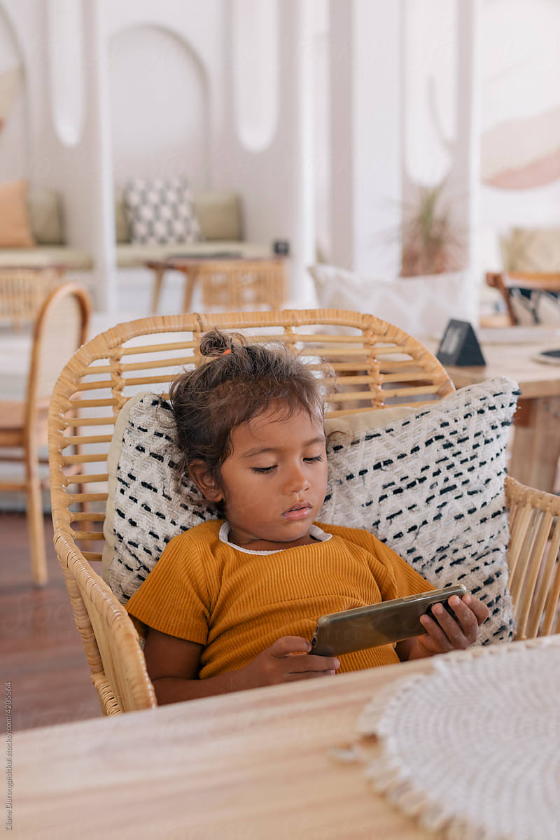 A Child Watching Something on Cell Phone