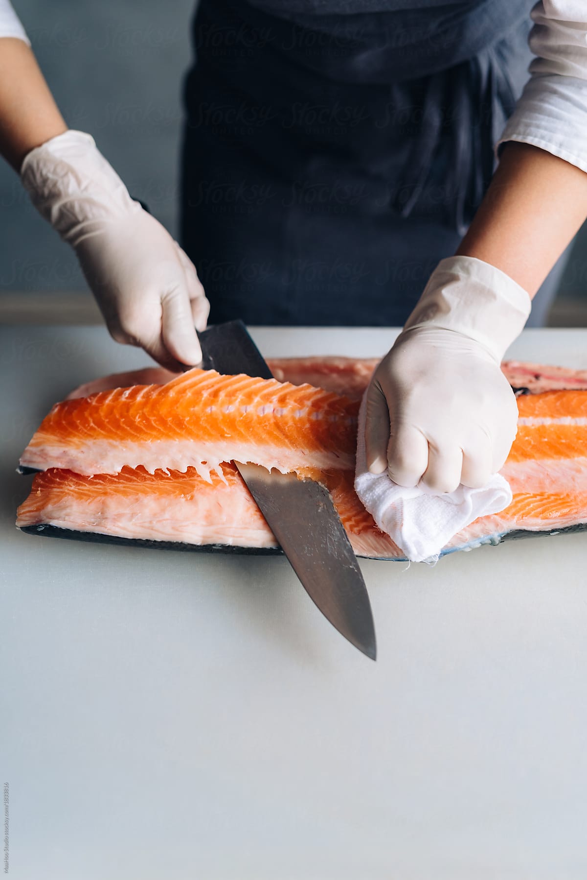 Chef cutting a fillet of salmon