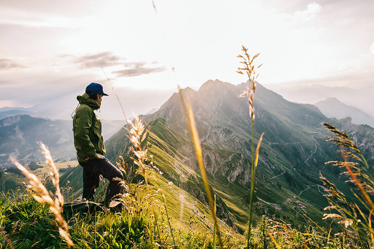 Male Hiker Watching Sunrise in Swiss Mountains