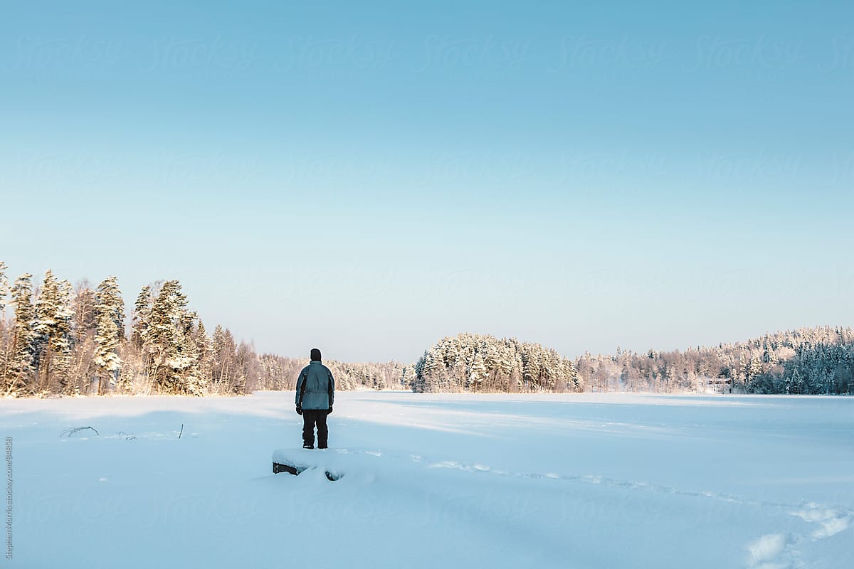 Lone Man Looking out on Winter Landscape