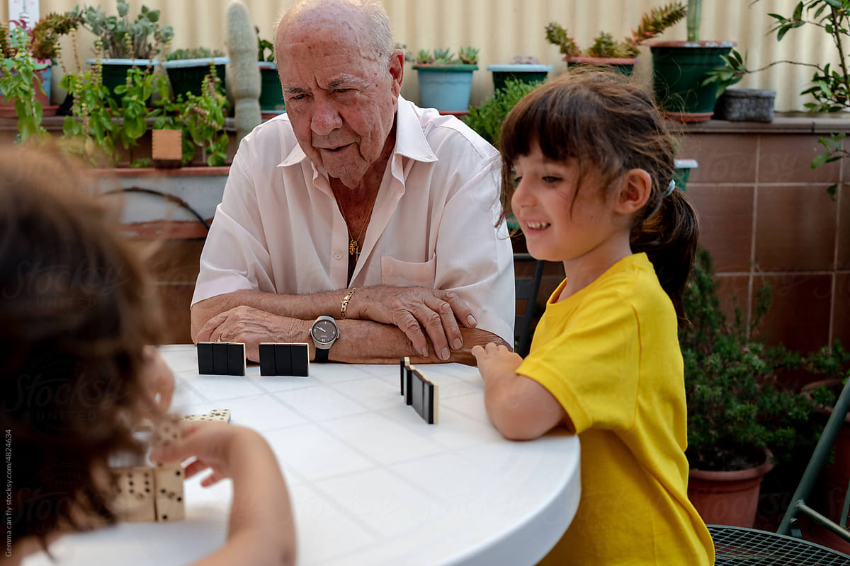 Family time playing domino with grandfather in a residence