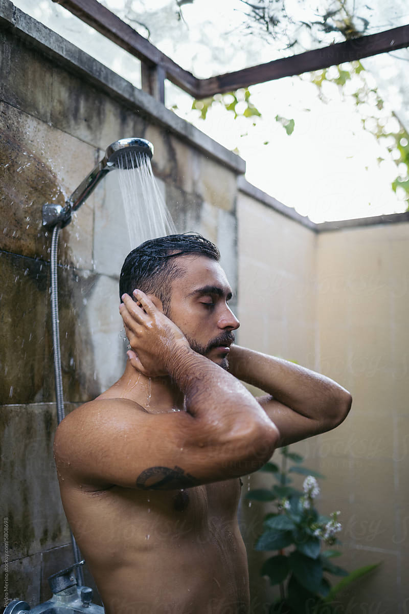 Man relaxing under the shower water
