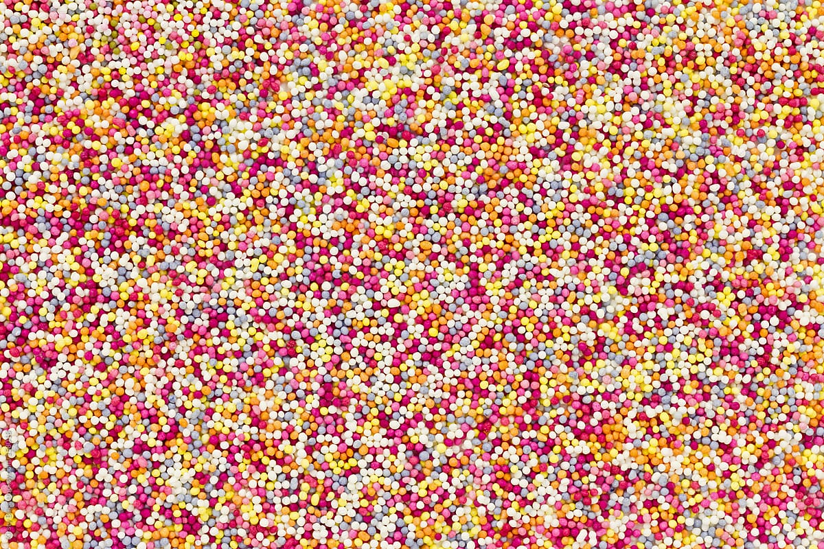 Colourful round sweet sprinkles overhead (hundreds and thousands)