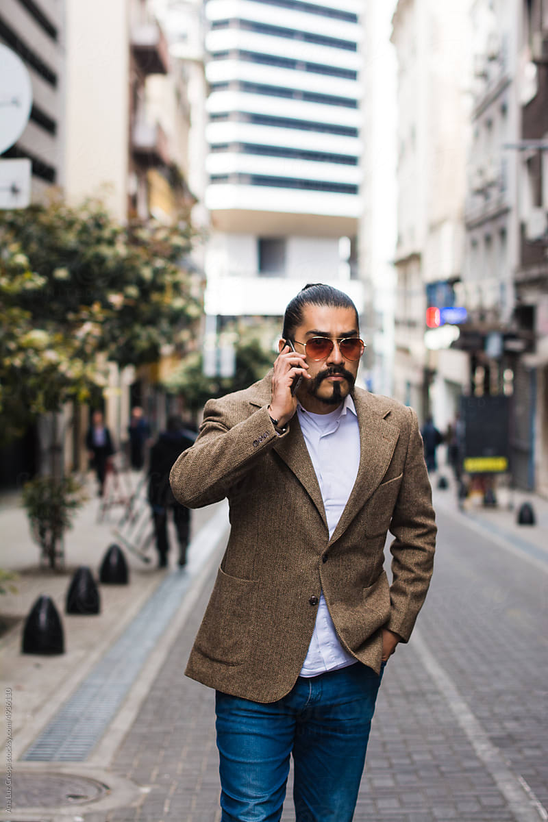 Business man walking and talking on the phone