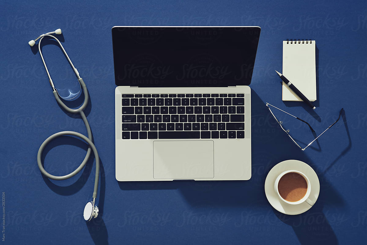 Modern doctor desktop with cup of coffee, laptop