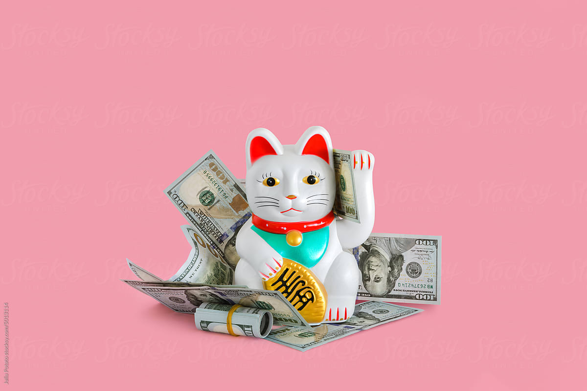 Chinese lucky waving cat with money around it