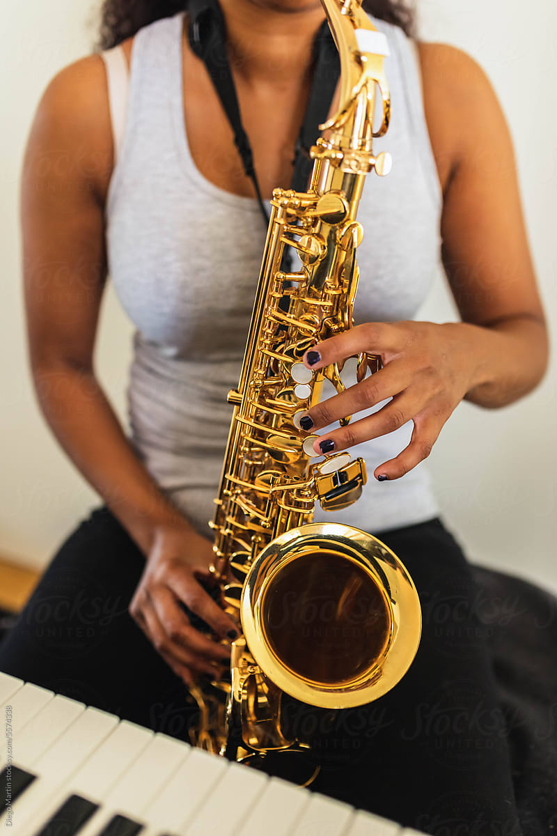 Unrecognizable woman playing saxophone