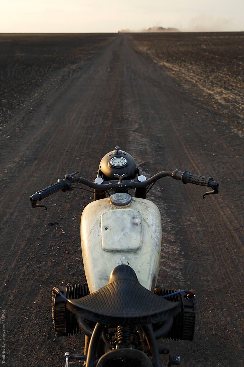 Retro motorcycle on dusty road