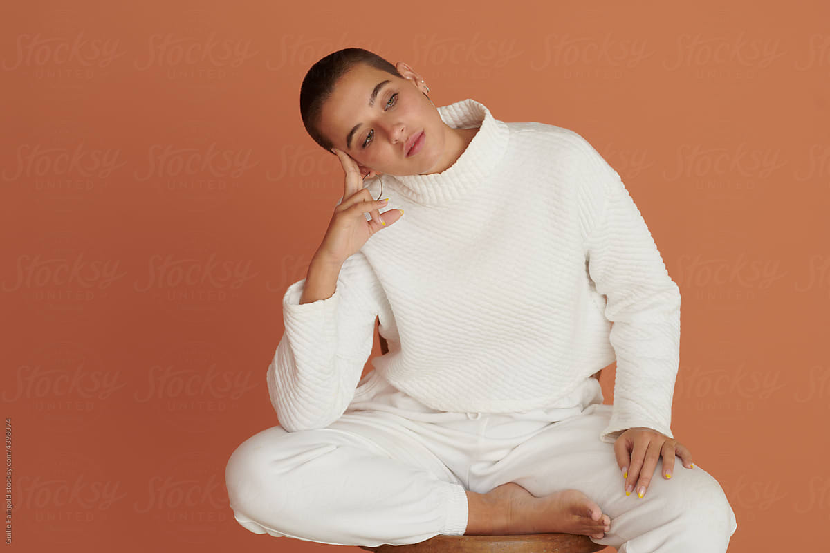 Calm girl in white with pensive look.