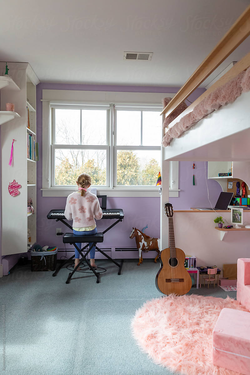 Girl  bedroom interior in home with girl Playing keyboard piano