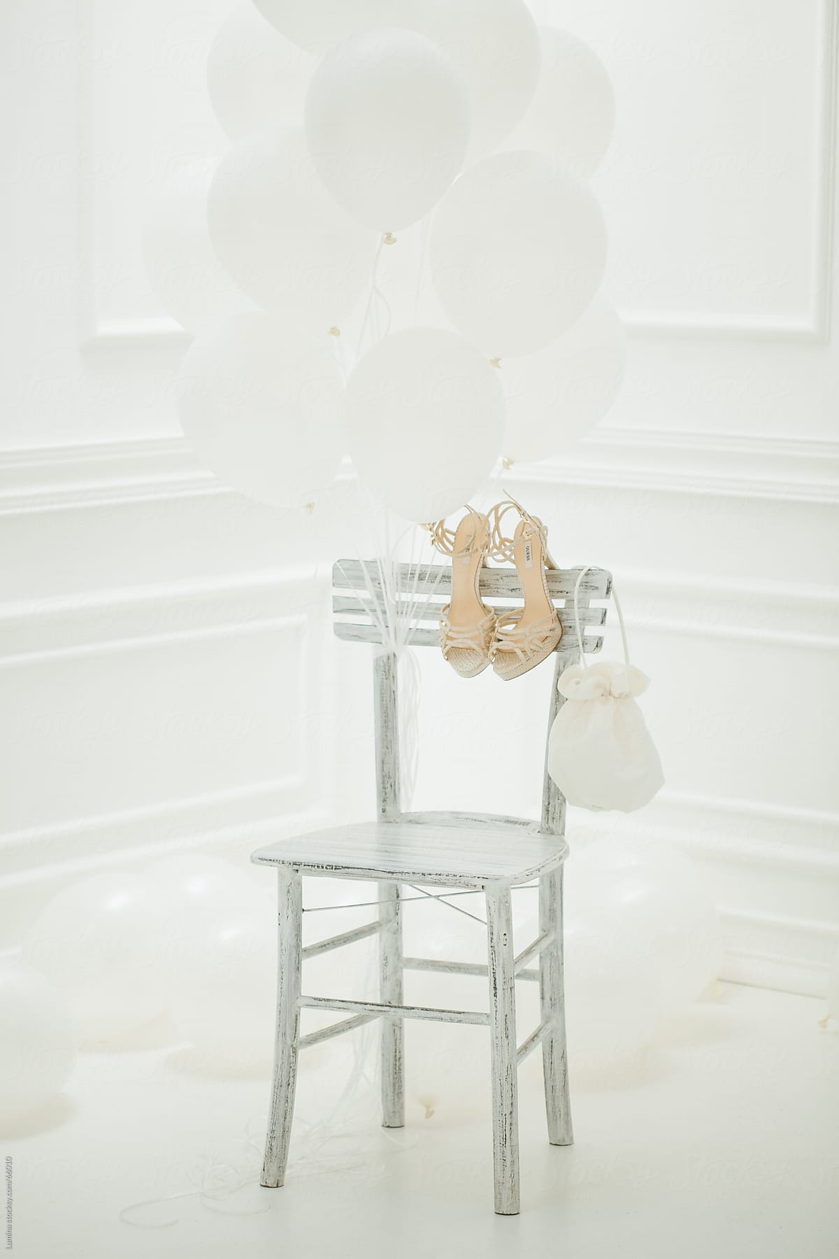 Bride's Shoes and Purse on a White Chair