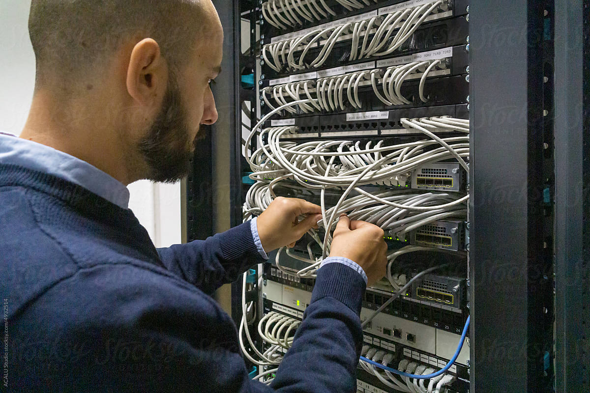 Computer technician working with a server rack