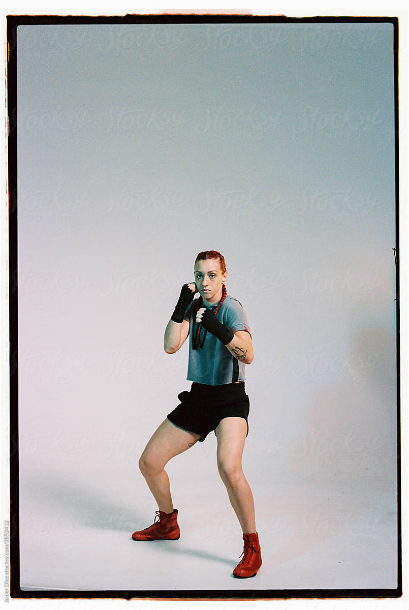 Strong woman in sportswear standing in fighting stance