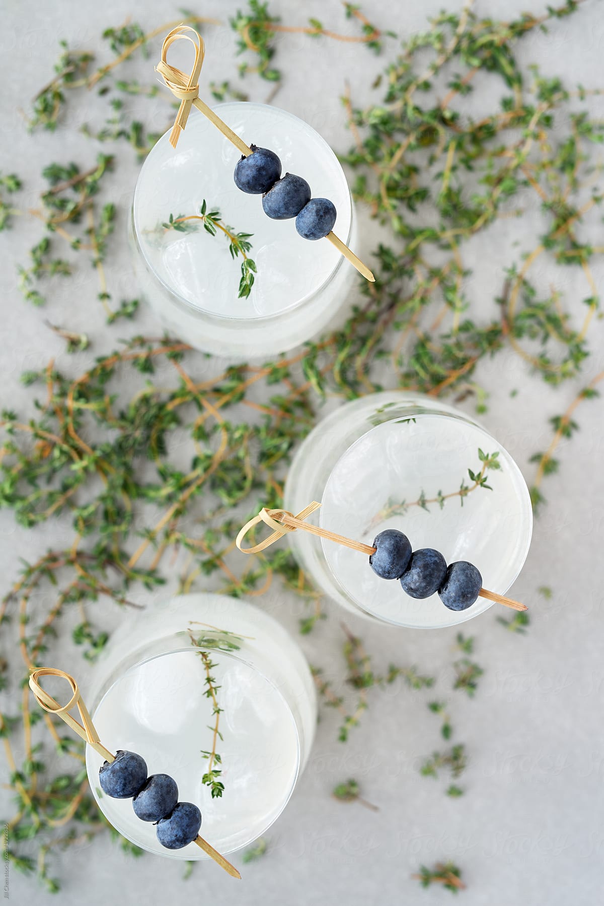 Overhead of cocktails with blueberry and thyme