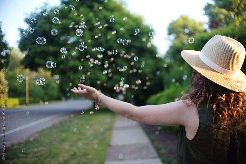 A young woman blowing bubbles