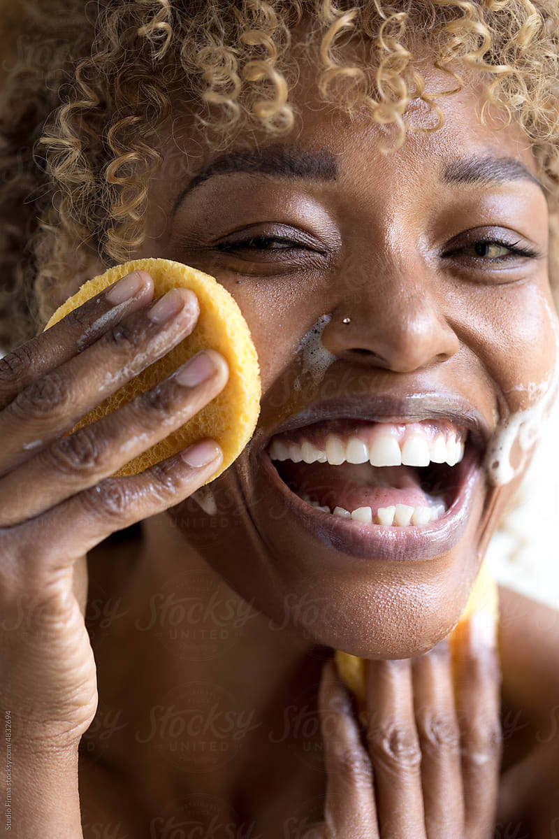 Woman Washing Her Face with Sponge