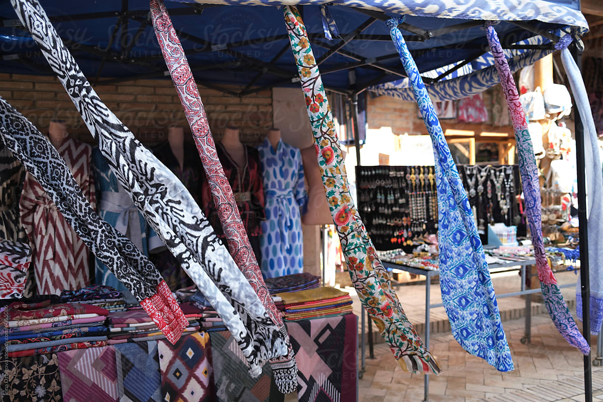 Colorful Display of Traditional Textiles at an Outdoor Market Stall