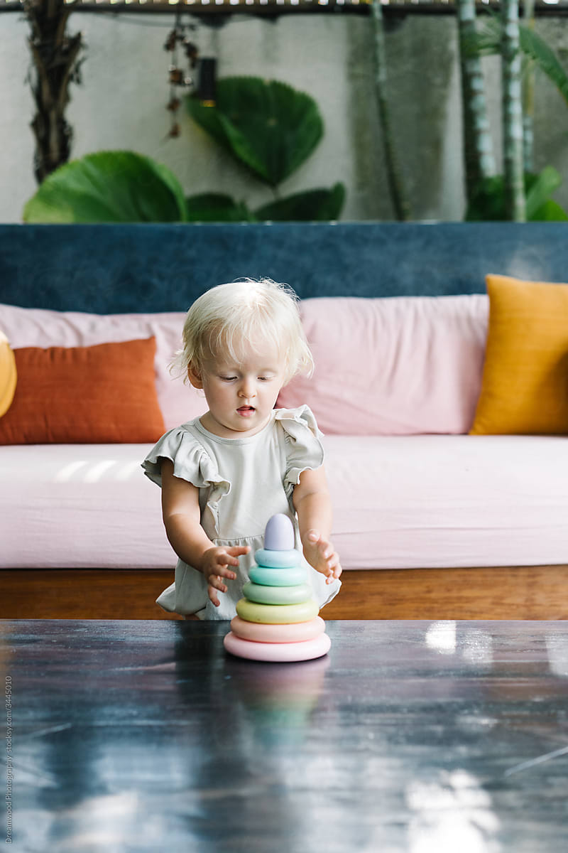 Cute baby playing with toy at home