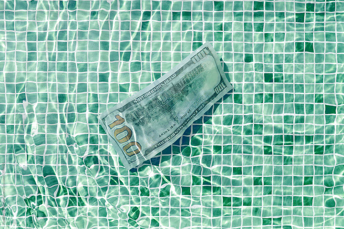 Close-up of swimming pool with dollar banknote.