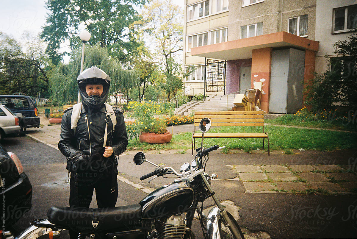 Man in helmet preparing for riding motorbike