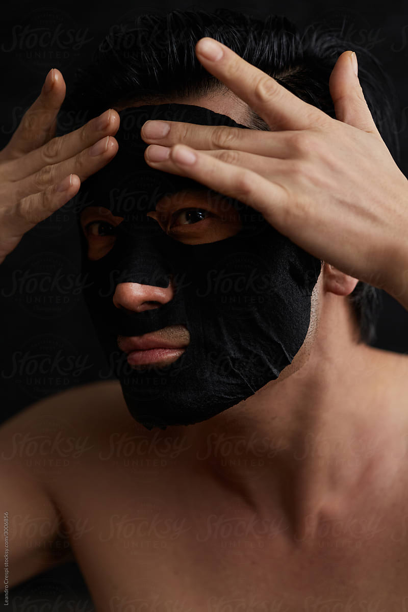 Asian man with skin care face mask