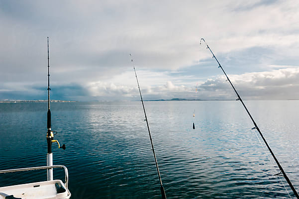 Fishing Rods Attached To the Stern of a White Yacht Against the Backdrop of  a Pier, Boats, Sea and Mountains. Close-up Stock Photo - Image of coast,  attached: 219853438