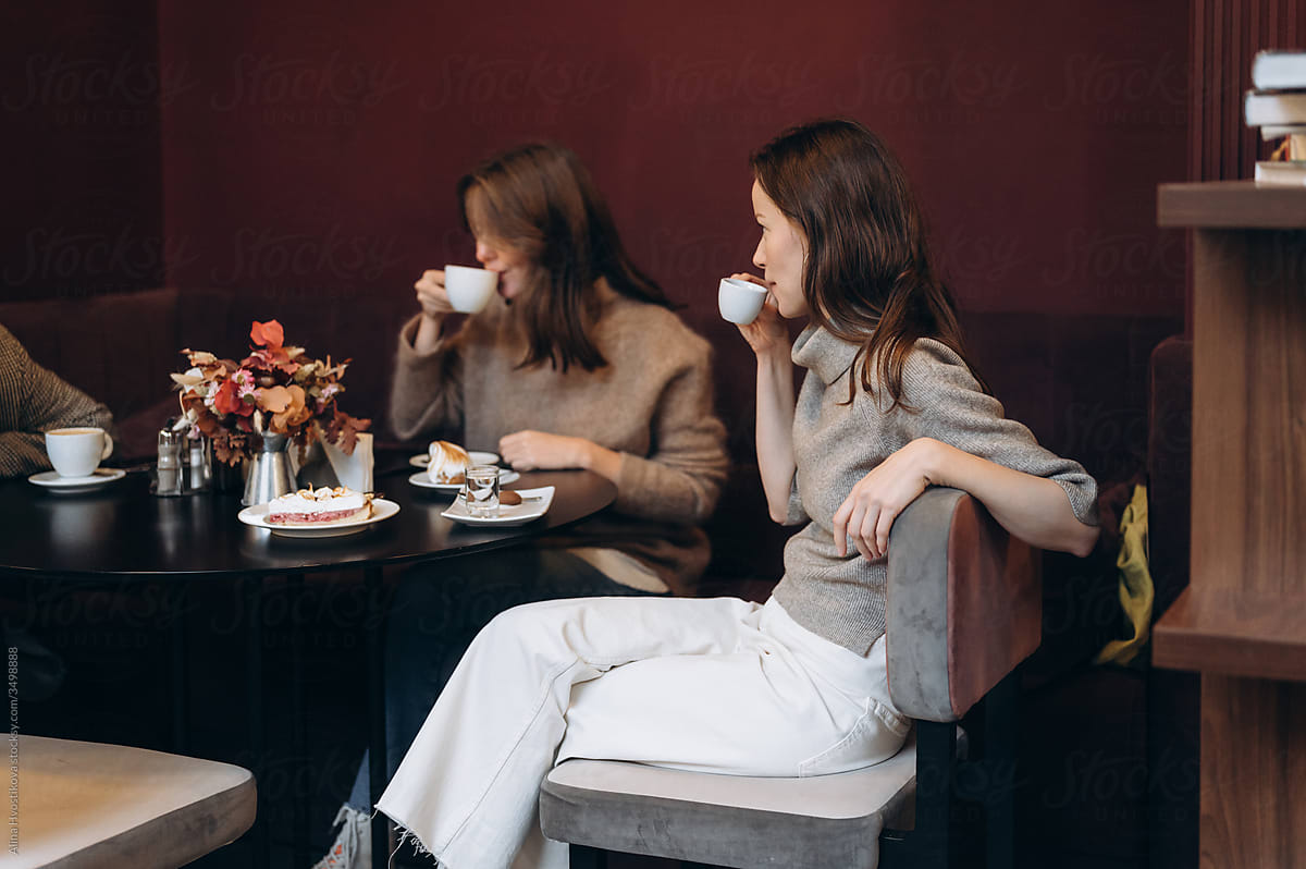Women drinking coffee in cafe at weekend