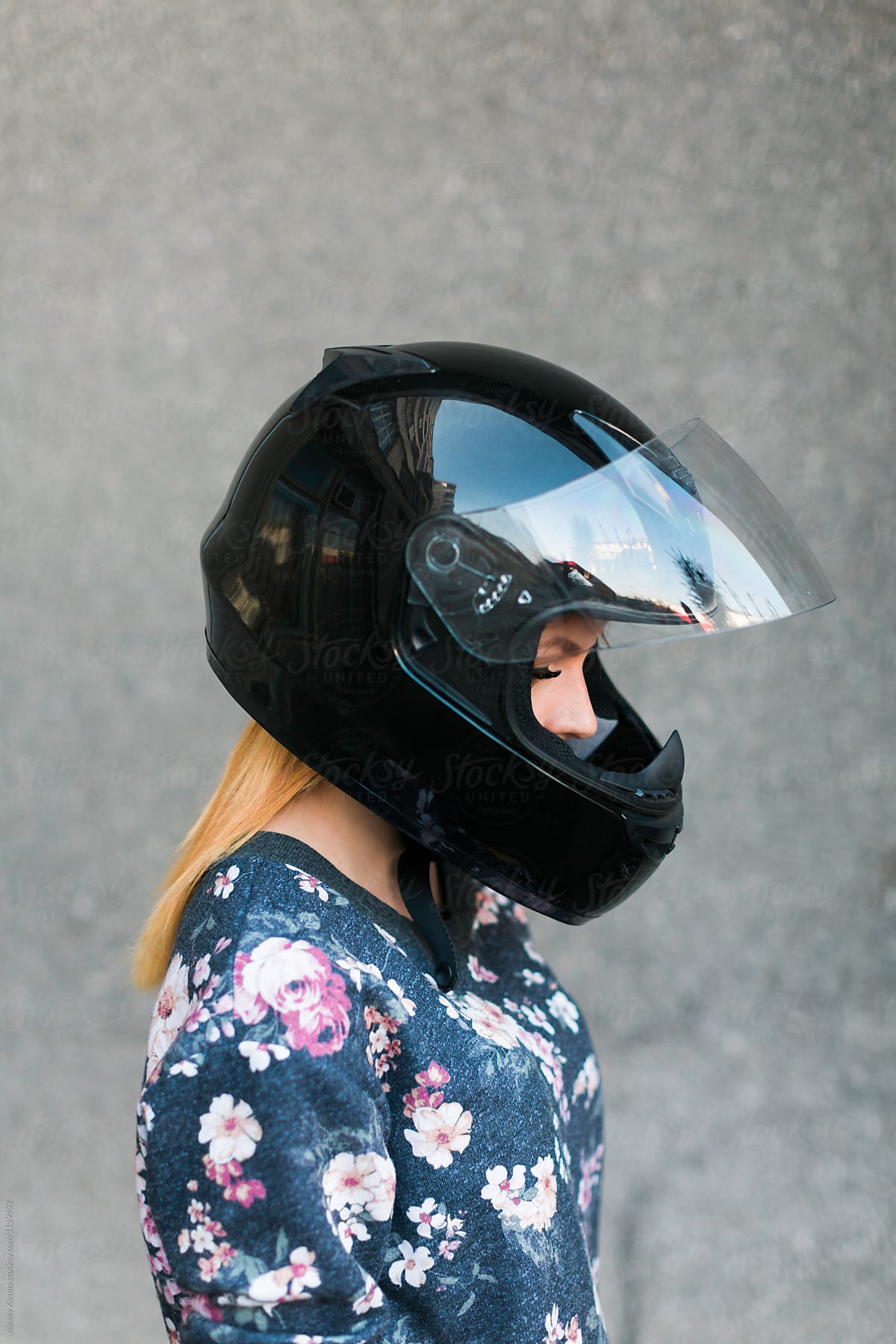cool young woman in a motorcycle helmet