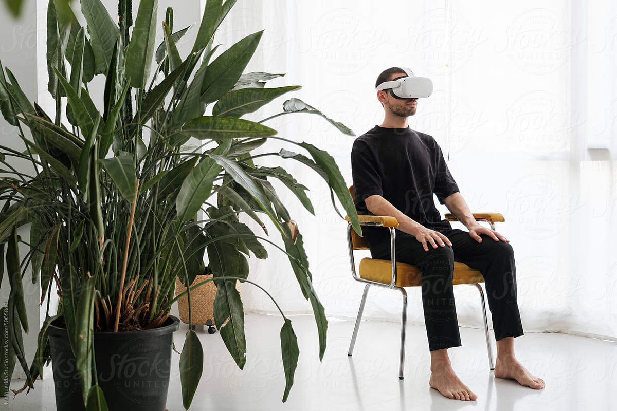 Relaxed man wearing VR headset
