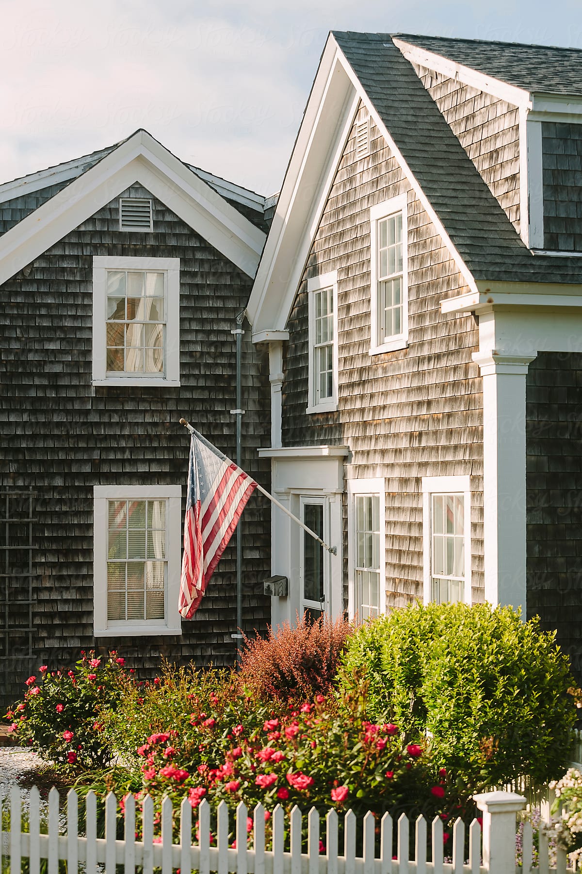 Cape Cod Style House with American Flag
