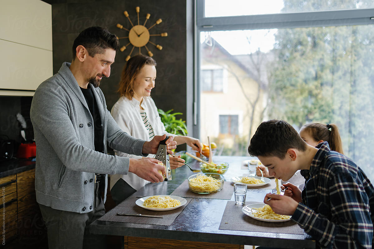Dwelling. Happiness. Tasty pasta. Kitchen area. Family together