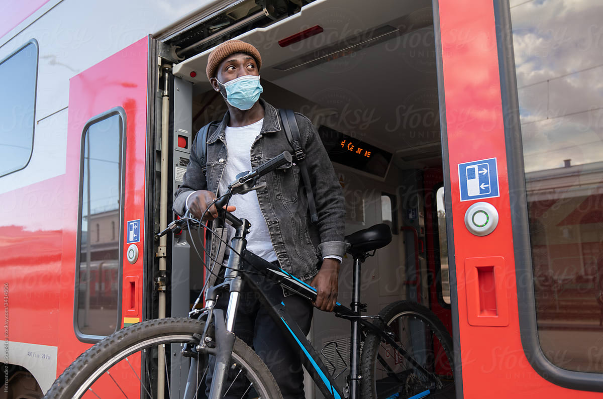 Man Wearing Mask With Bicycle In The Train