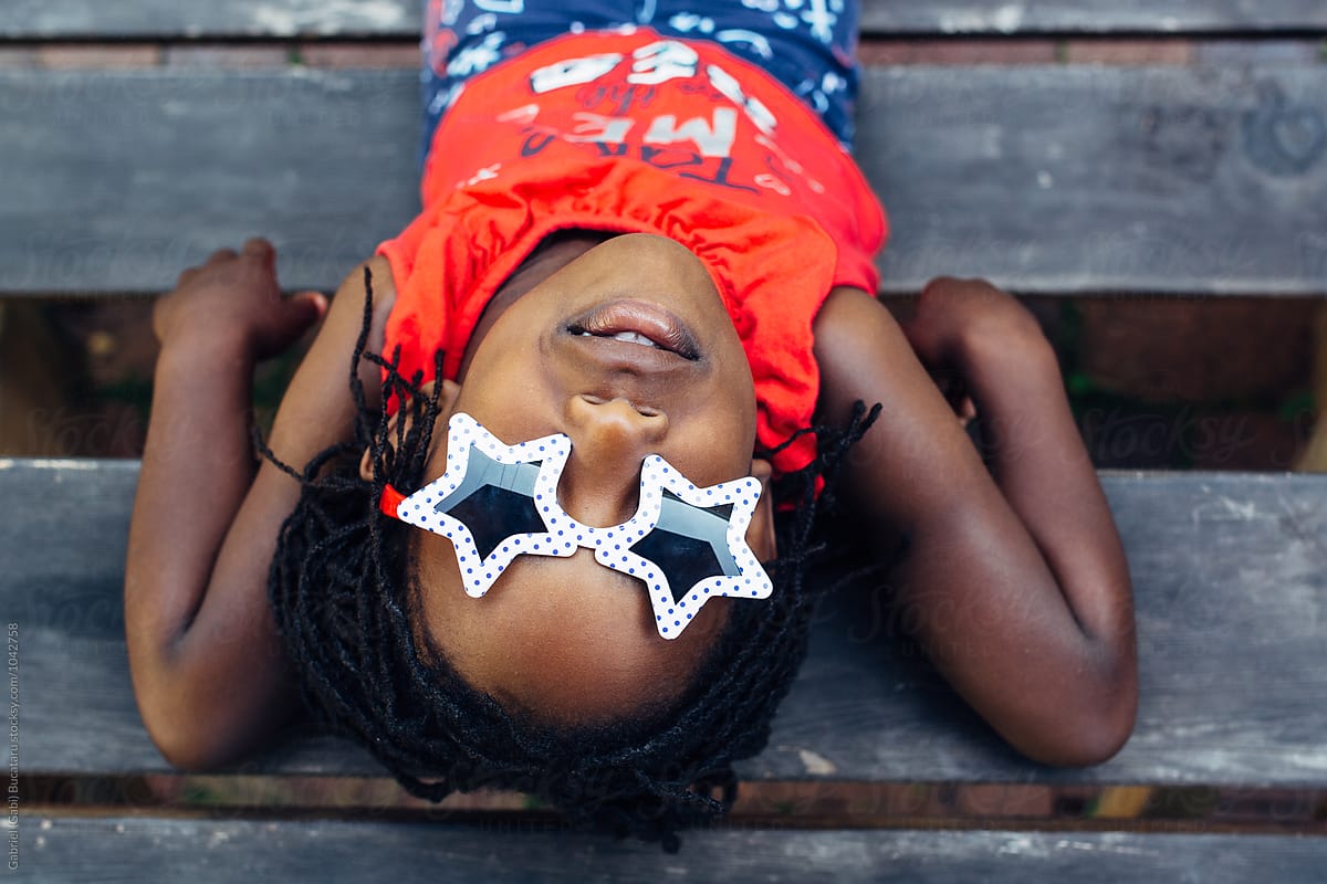 Black girl wearing USA themed sunglass