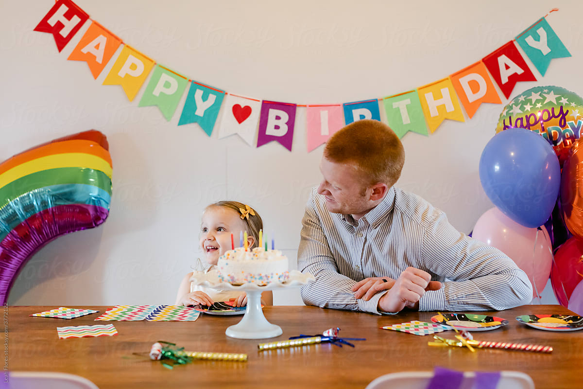 A Girl Smiles at Her Rainbow-Themed Birthday Party