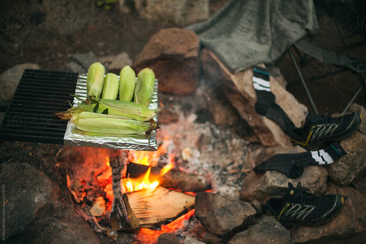 Corn on the cob cooking over a fire
