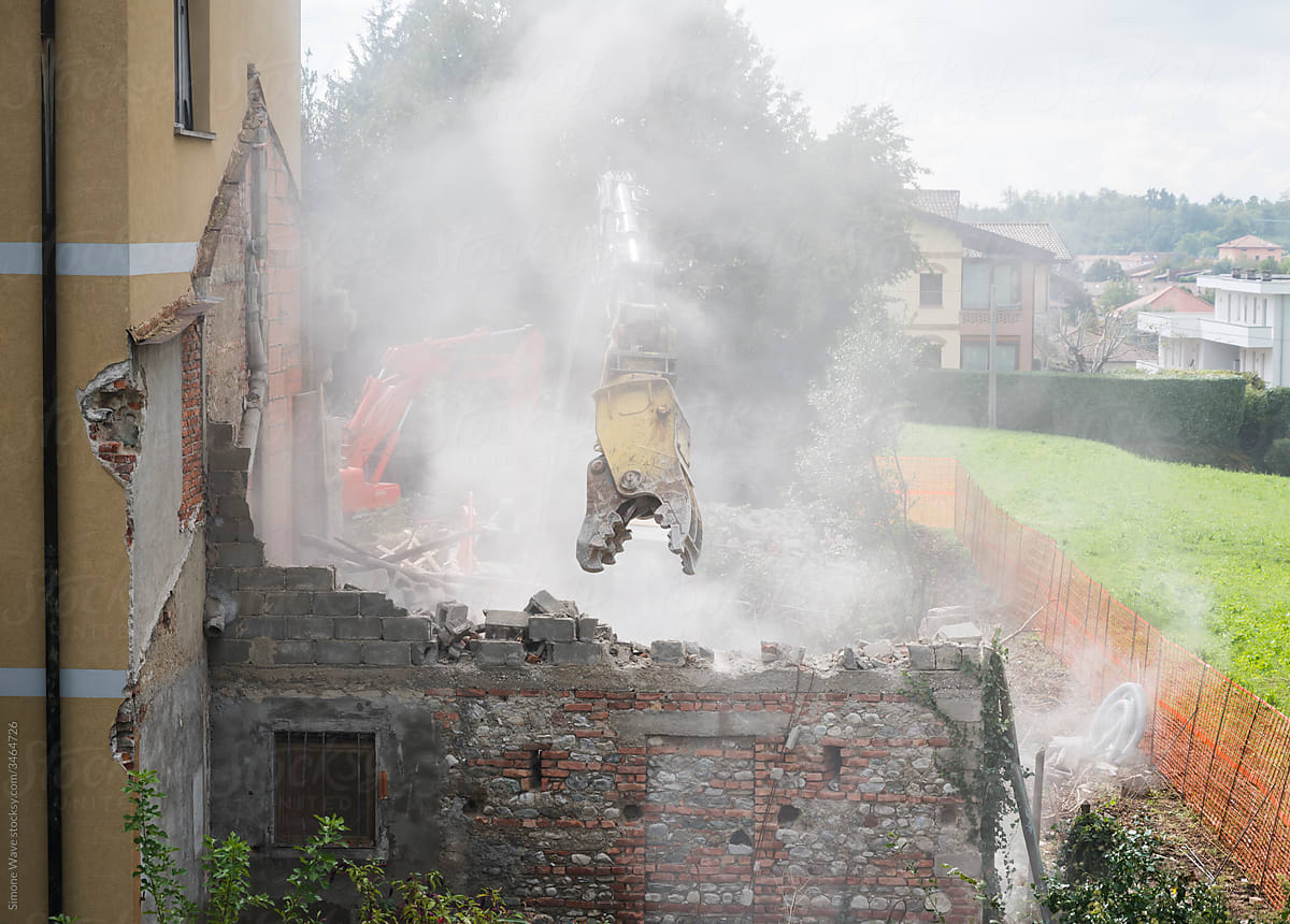 Crusher excavator machine during house demolition