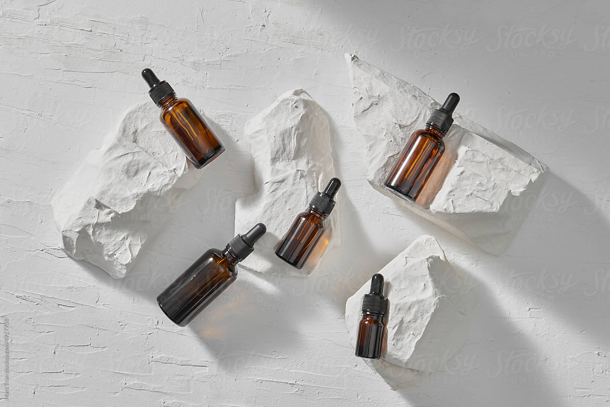 Glass dropper bottles with cosmetic oil, essential or serum